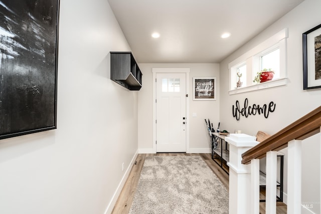 entrance foyer featuring plenty of natural light, wood finished floors, and baseboards