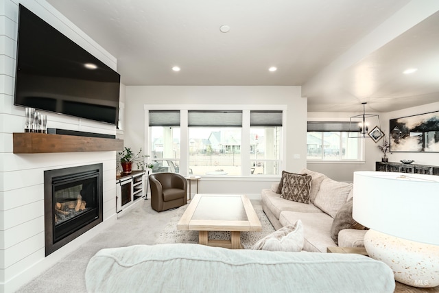 living room with carpet flooring, recessed lighting, and a glass covered fireplace