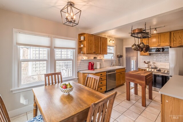 dining area featuring light tile patterned floors, a chandelier, and baseboards