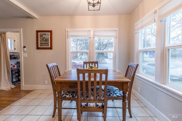 dining area featuring light tile patterned floors and baseboards