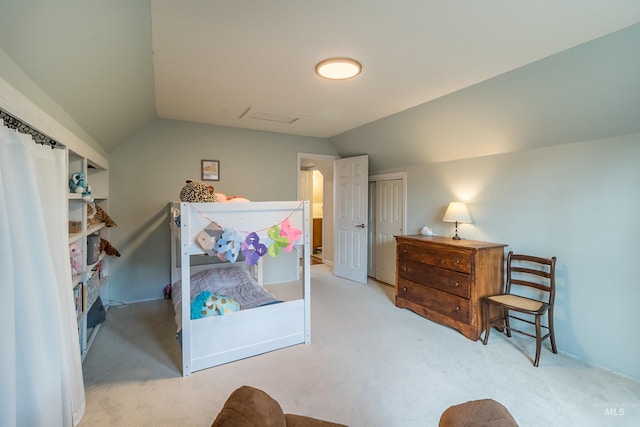 carpeted bedroom featuring a closet and vaulted ceiling