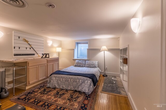 bedroom featuring baseboards and hardwood / wood-style floors