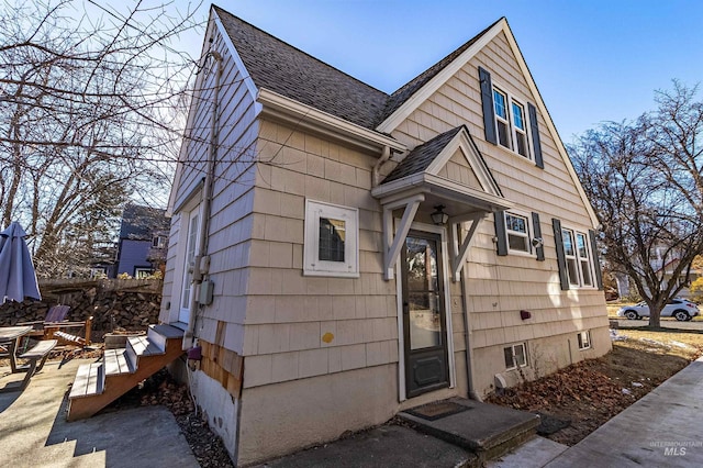 view of front of house with entry steps and roof with shingles