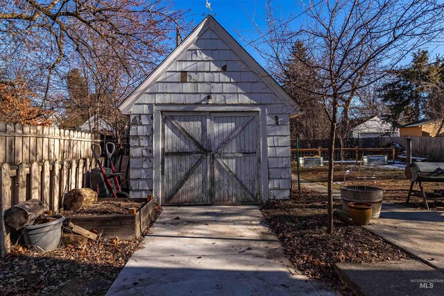 view of shed featuring fence
