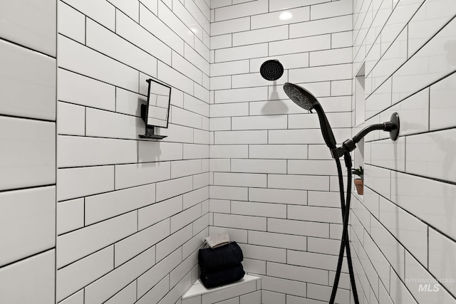 bathroom with a tile shower