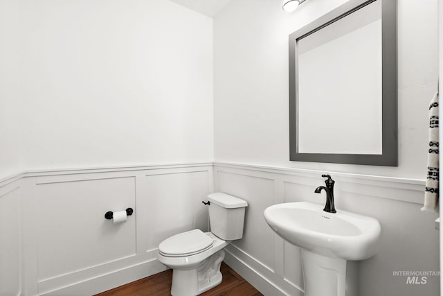 bathroom with sink, hardwood / wood-style floors, and toilet