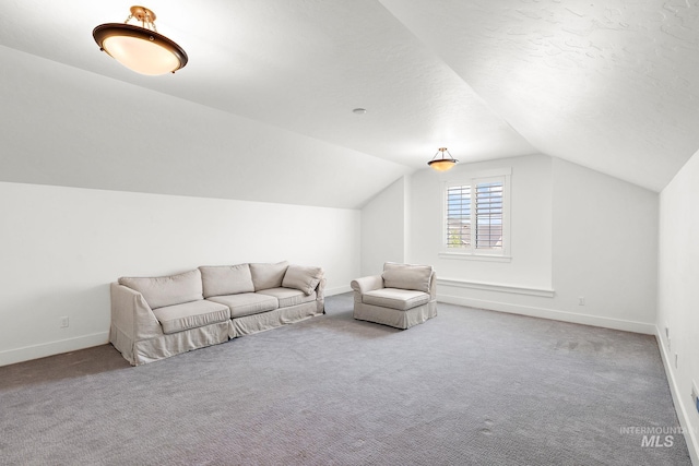 unfurnished room featuring carpet flooring and vaulted ceiling