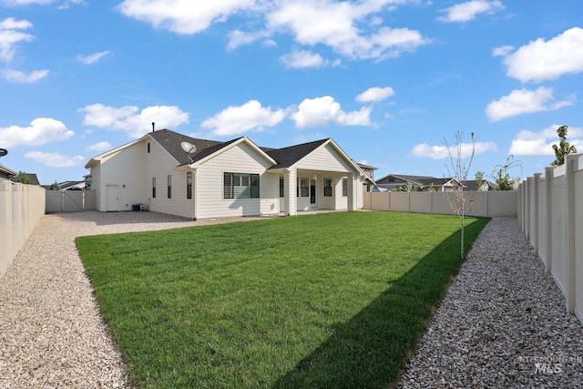 back of property with a yard and a patio area