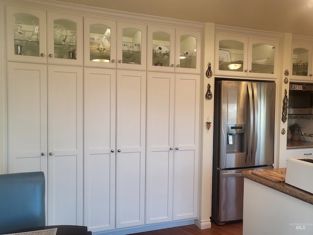 kitchen featuring white cabinetry, dark hardwood / wood-style floors, and stainless steel refrigerator with ice dispenser