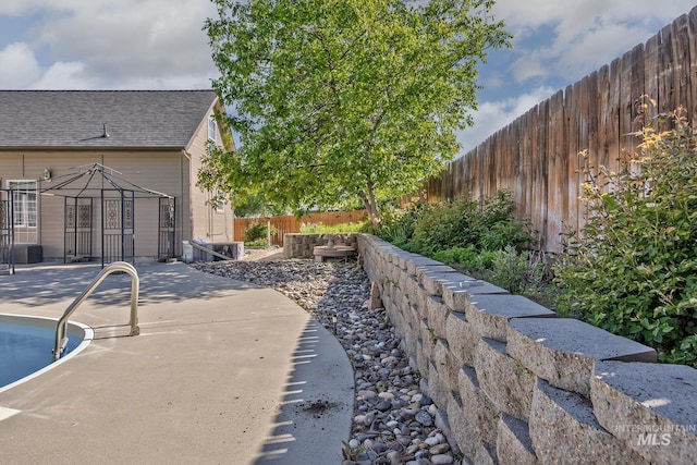 view of patio with a garden, a gazebo, a fenced in pool, and a fenced backyard