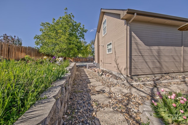 view of side of property featuring fence