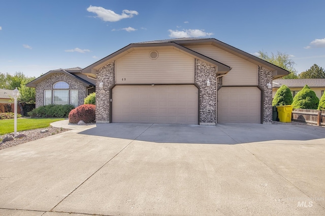 ranch-style house with driveway, brick siding, and a garage