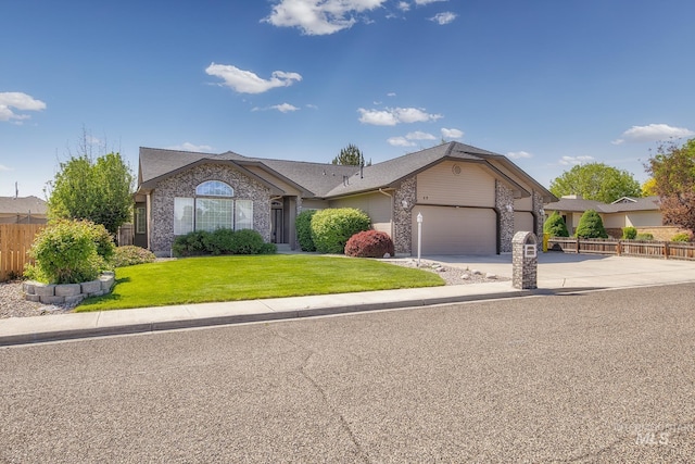 ranch-style house featuring fence, an attached garage, brick siding, driveway, and a front lawn