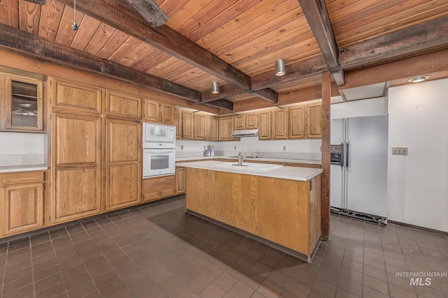 kitchen with white appliances, light countertops, under cabinet range hood, beamed ceiling, and wood ceiling