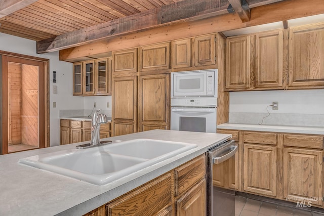 kitchen with beam ceiling, white appliances, light countertops, wooden ceiling, and a sink