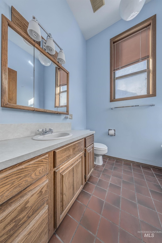 bathroom with visible vents, tile patterned floors, toilet, and vanity