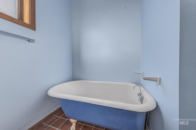 bathroom featuring a freestanding bath and tile patterned flooring