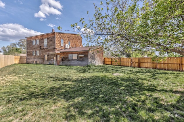 back of property featuring a lawn, a fenced backyard, central air condition unit, and a chimney