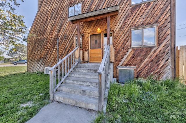 doorway to property with a yard