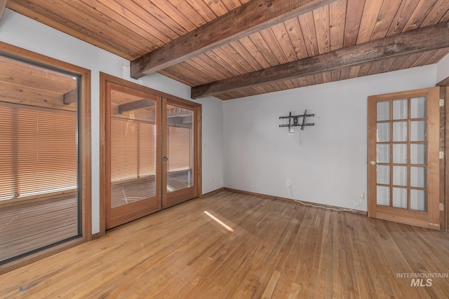 empty room with beamed ceiling, wooden ceiling, french doors, and hardwood / wood-style floors