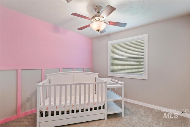 2513 S Vineyard St, Nampa, ID 83686 - carpeted bedroom with a crib, ceiling fan, and baseboards