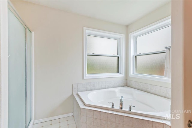 2513 S Vineyard St, Nampa, ID 83686 - full bathroom with a bath, a stall shower, and baseboards