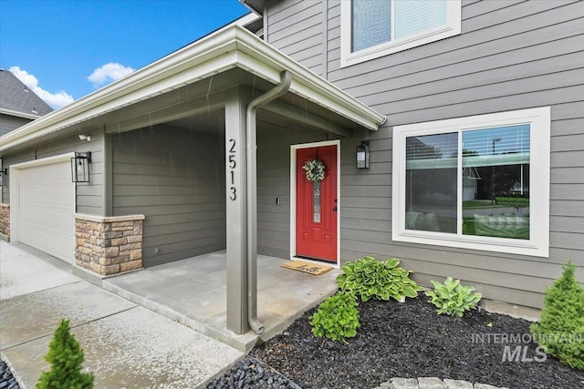 2513 S Vineyard St, Nampa, ID 83686 - property entrance with a garage and stone siding