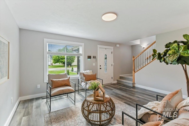 2513 S Vineyard St, Nampa, ID 83686 - living area featuring stairs, wood finished floors, and baseboards