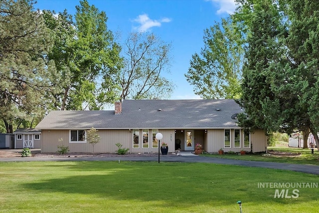 7301 W Diamond St, Boise, ID 83709 - rear view of house with a lawn and a chimney