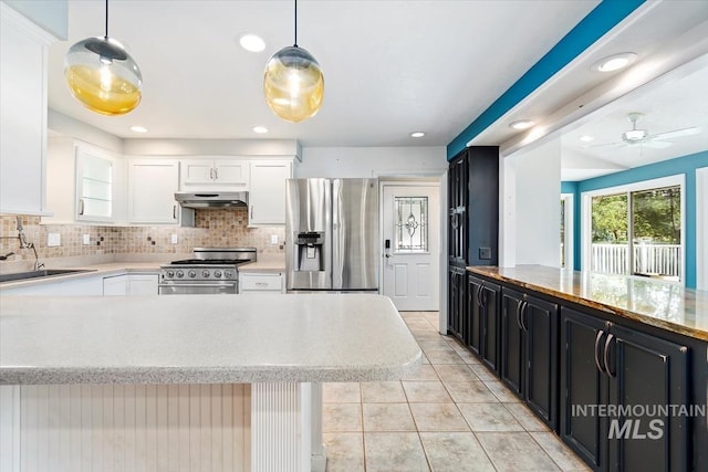 7301 W Diamond St, Boise, ID 83709 - kitchen featuring stainless steel appliances, dark cabinetry, a sink, under cabinet range hood, and white cabinets