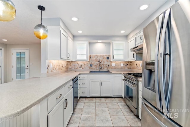 7301 W Diamond St, Boise, ID 83709 - kitchen featuring stainless steel appliances, a sink, under cabinet range hood, white cabinetry, and light countertops