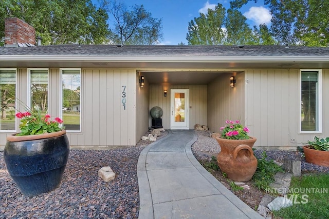 7301 W Diamond St, Boise, ID 83709 - view of exterior entry featuring a shingled roof and a chimney