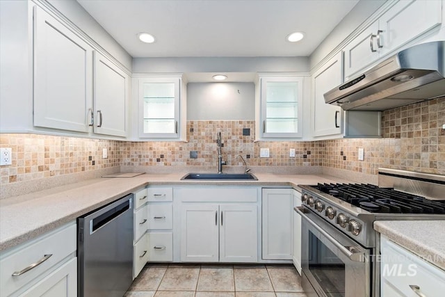 7301 W Diamond St, Boise, ID 83709 - kitchen featuring stainless steel appliances, under cabinet range hood, a sink, white cabinets, and light countertops