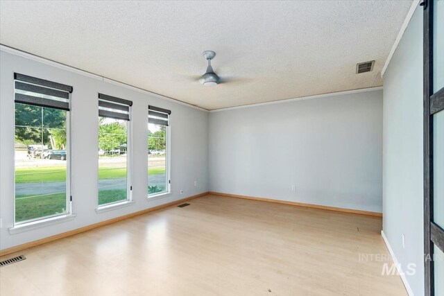 7301 W Diamond St, Boise, ID 83709 - spare room with a textured ceiling, crown molding, light wood-type flooring, ceiling fan, and baseboards