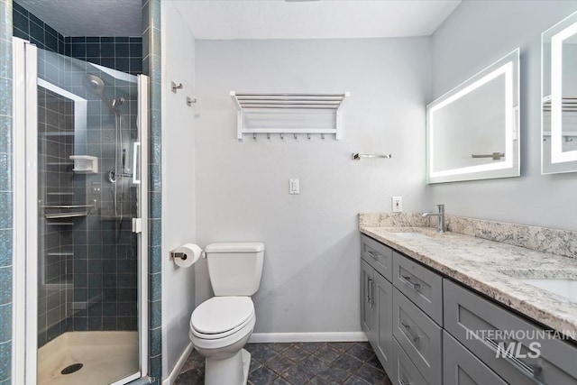 7301 W Diamond St, Boise, ID 83709 - bathroom featuring double vanity, a shower stall, toilet, and baseboards
