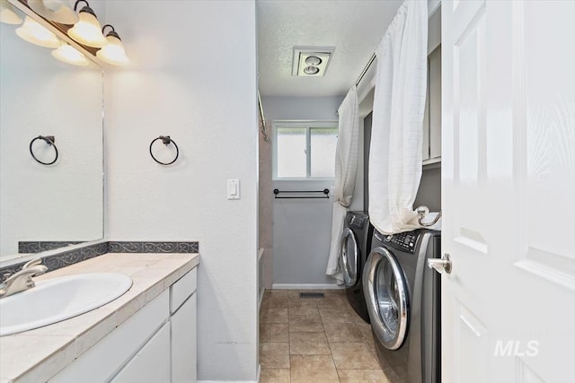 7301 W Diamond St, Boise, ID 83709 - full bathroom featuring washing machine and dryer, vanity, shower / bath combo with shower curtain, tile patterned floors, and a textured ceiling