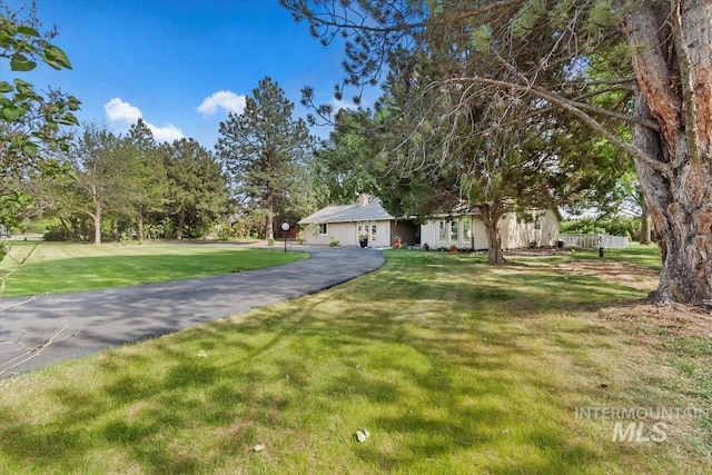 7301 W Diamond St, Boise, ID 83709 - ranch-style house featuring a front lawn and asphalt driveway