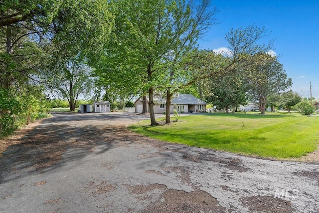 7301 W Diamond St, Boise, ID 83709 - single story home with driveway, a front lawn, an attached garage, and an outdoor structure