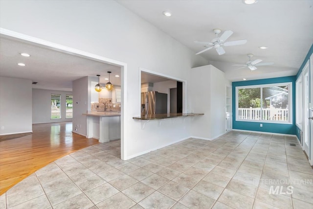 7301 W Diamond St, Boise, ID 83709 - unfurnished living room with light tile patterned flooring, lofted ceiling, recessed lighting, a ceiling fan, and baseboards