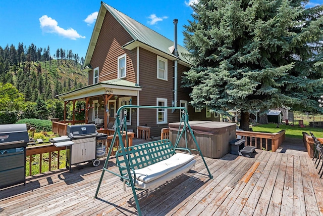 wooden deck featuring a grill and a hot tub