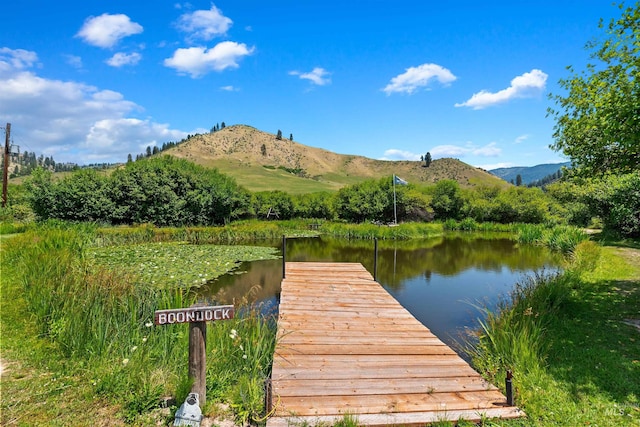 view of dock featuring a water and mountain view