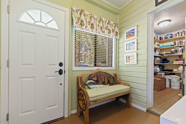 foyer with wooden walls and light hardwood / wood-style flooring