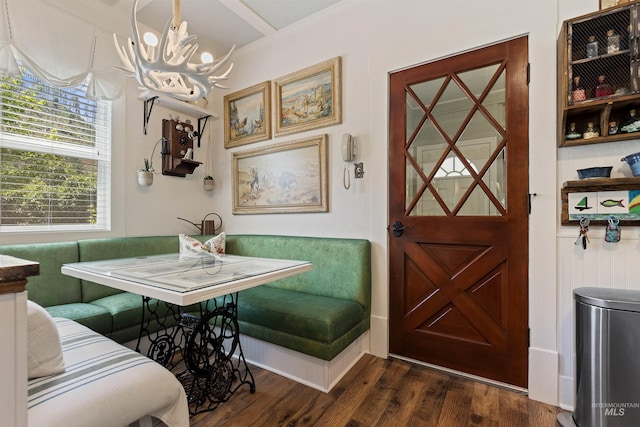 dining space featuring breakfast area, a notable chandelier, and dark hardwood / wood-style floors