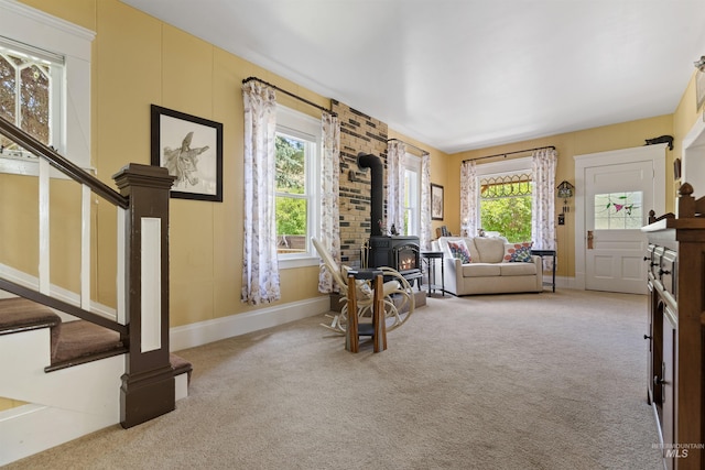 sitting room with carpet floors and a wood stove