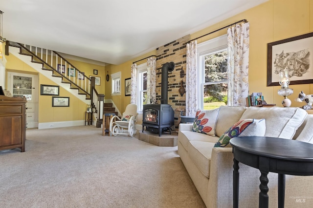 carpeted living room with a wood stove