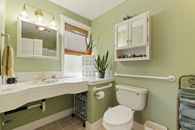 bathroom with tile patterned floors, toilet, and sink