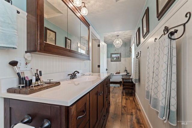 bathroom with vanity, a chandelier, and wood-type flooring