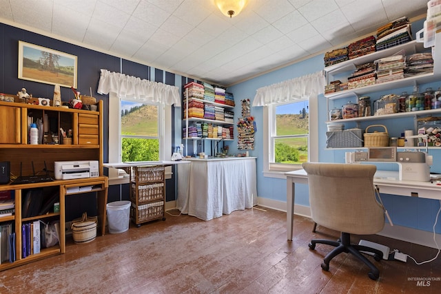 office featuring wood-type flooring, a healthy amount of sunlight, and crown molding