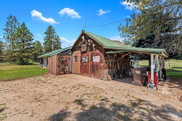 view of outbuilding featuring a yard