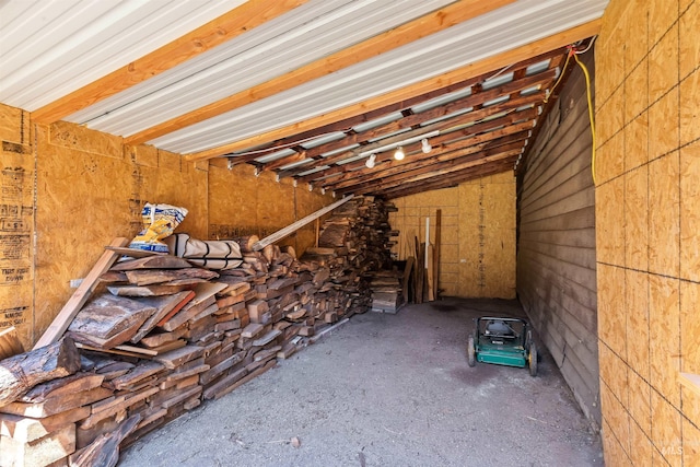 misc room with lofted ceiling and a wood stove